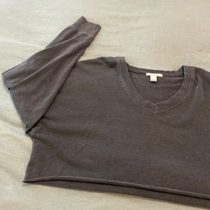 Cropped, long sleeve, dark gray, light shirt.